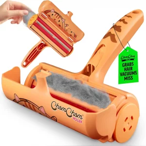 Limited edition cat design ChomChom roller with the lid open, revealing a chamber full of trapped gray fur and the brush mechanism.