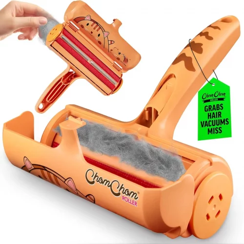 Limited edition cat design ChomChom roller with the lid open, revealing a chamber full of trapped gray fur and the brush mechanism.