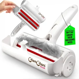 Open ChomChom roller showing red static bristles and trapped hair, demonstrating how it grabs pet hair vacuums miss.